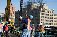 Here we can see a variety of workers waiting for their required step in the process. Juding by the different coloured hard hats, I can see two different specialists, and probably some site engineers or supervisors. (Weekend At Work/Metro Transportation)