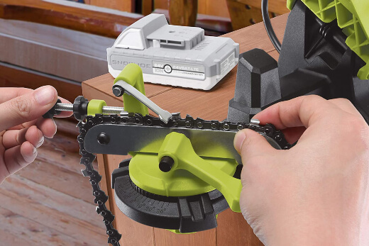 A chainsaw sharpener being used