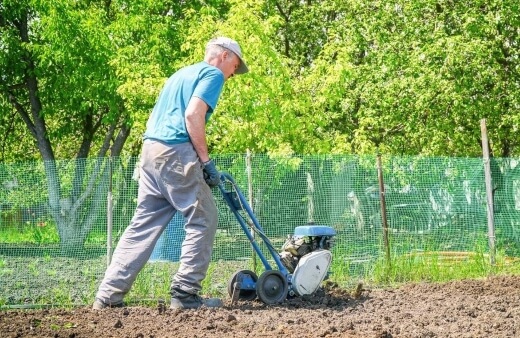 A man using a cultivator