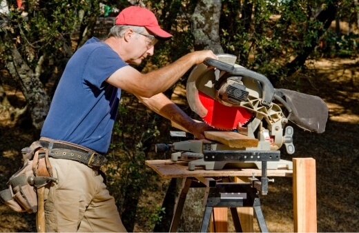 A man using a mitre saw stand