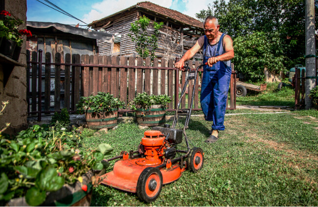 A man using a lawn mower