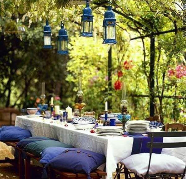 Dining area beneath a lush garden canopy